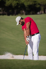 Image showing golfer hitting a sand bunker shot