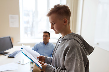 Image showing student boy with notebook and teacher at school