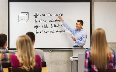 Image showing group of students and happy teacher at white board