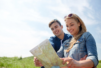 Image showing happy couple with map outdoors