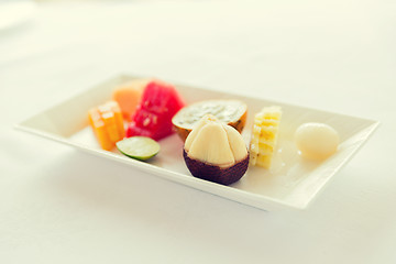 Image showing plate of fresh juicy fruit dessert at restaurant