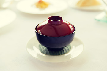 Image showing ceramic pot with hot dish on restaurant table