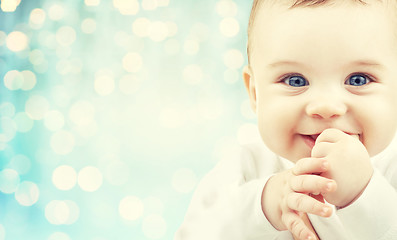 Image showing happy baby face over blue holidays lights