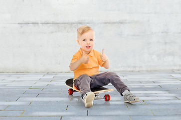 Image showing happy little boy on skateboard showing thumbs up