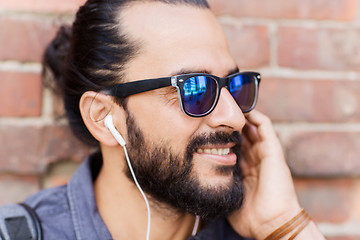 Image showing happy man with earphones listening to music