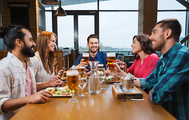 Image showing friends dining and drinking beer at restaurant