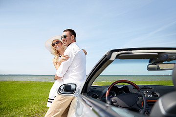 Image showing happy couple hugging near cabriolet car at sea