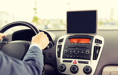 Image showing close up of young man with tablet pc driving car