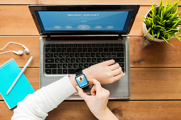 Image showing close up of woman with smart watch and laptop