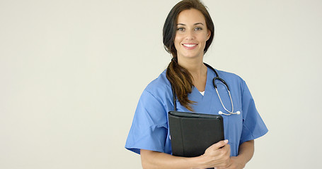 Image showing Smiling young female physician smiles at camera