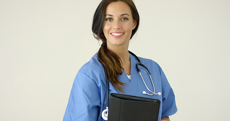 Image showing Smiling young female physician smiles at camera