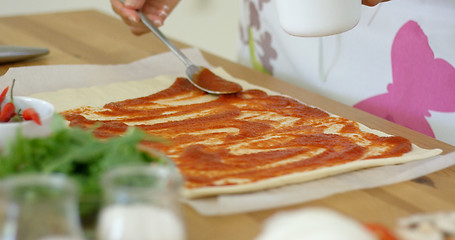 Image showing Woman making a traditional Italian pizza