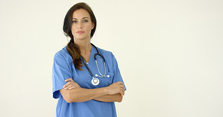 Image showing Woman in scrubs crosses arms and smiles at camera