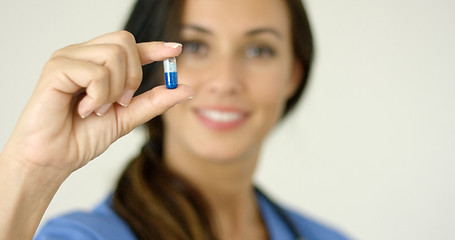 Image showing Doctor or nurse holding up a capsule