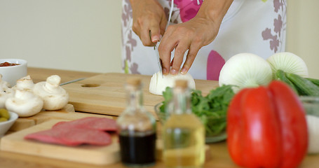 Image showing Close up on hands Cutting fresh onion