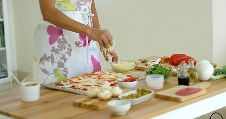 Image showing Woman preparing a homemade pizza in the kitchen