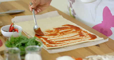 Image showing Woman preparing traditional homemade pizza