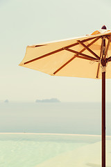 Image showing view from infinity edge pool with parasol to sea