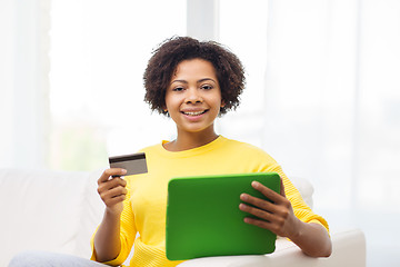 Image showing happy african woman with tablet pc and credit card