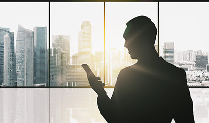 Image showing silhouette of businessman with smartphone