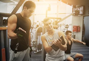 Image showing men exercising on gym machine