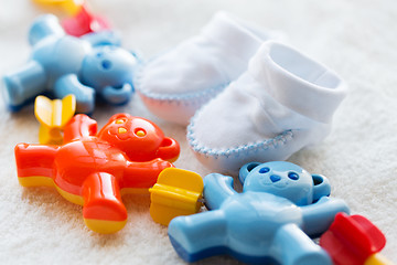 Image showing close up of baby rattle and bootees for newborn