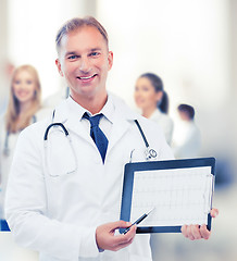 Image showing male doctor with stethoscope showing cardiogram