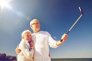 Image showing seniors with smartphone taking selfie on beach