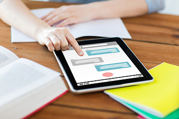 Image showing close up of student with tablet pc and notebook