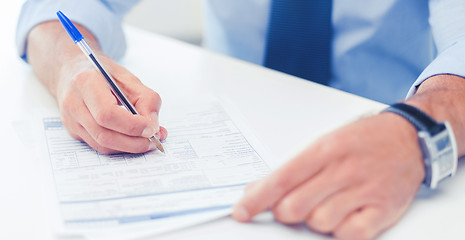 Image showing man filling tax form