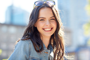 Image showing happy smiling young woman on summer city street