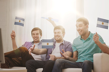 Image showing happy male friends with flags and vuvuzela