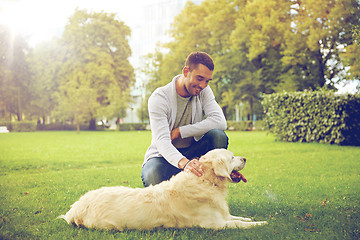 Image showing happy man with labrador dog walking in city