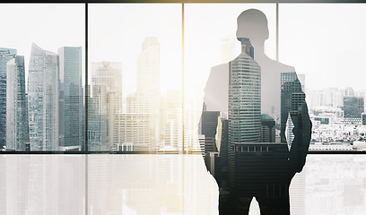 Image showing silhouette of business man over office background