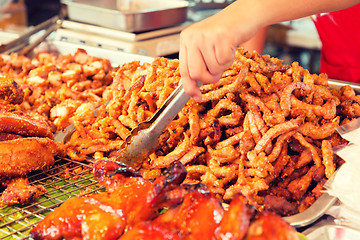 Image showing close up of cook hands and snacks at street market