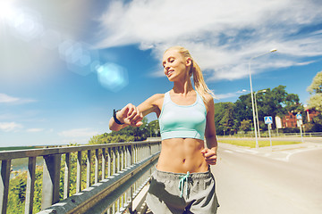 Image showing smiling young woman running outdoors