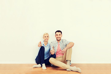 Image showing happy couple showing thumbs up at new home