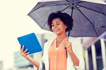 Image showing businesswoman with umbrella and tablet pc in city