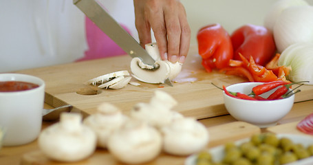 Image showing Housewife preparing dinner slicing fresh mushrooms