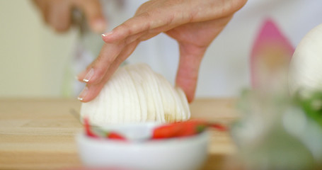 Image showing Close up on hands Cutting fresh onion