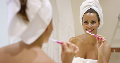 Image showing Young woman cleaning her teeth