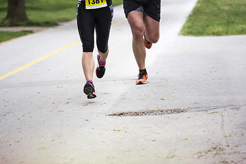 Image showing Young couple running in the city park