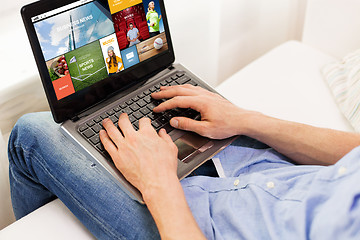 Image showing close up of man typing on laptop computer at home