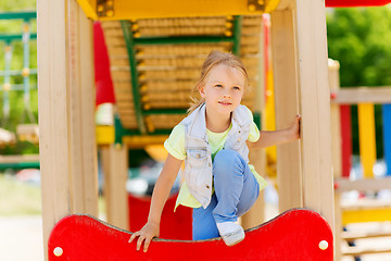 Image showing happy little girl climbing on children playground