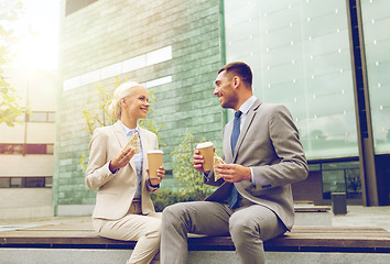 Image showing smiling businessmen with paper cups outdoors