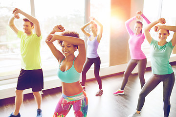 Image showing group of smiling people dancing in gym or studio