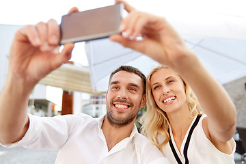 Image showing couple taking selfie with smatphone at restaurant