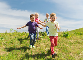 Image showing group of happy kids running outdoors