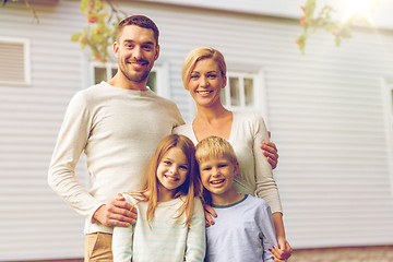 Image showing happy family in front of house outdoors