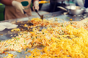 Image showing close up of cook frying wok at street market